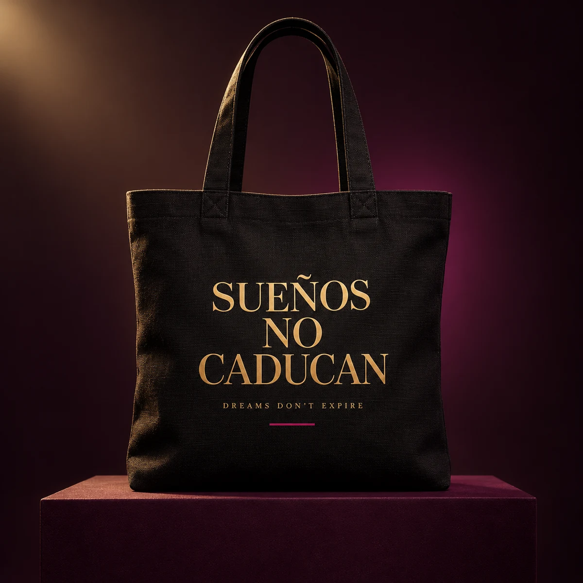 Concept preview of a black tote with gold Sueños No Caducan lettering